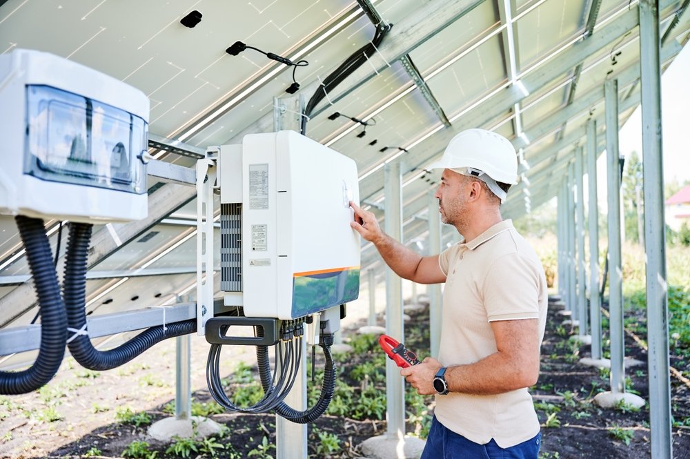 electrician checking voltage on solar inverter
