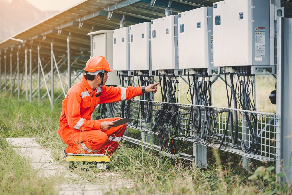 an electrician checking string inverter