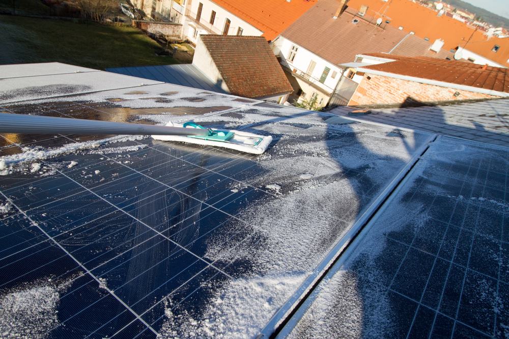 worker cleaning solar panels